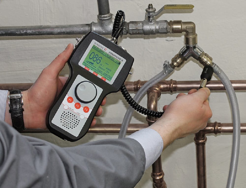 Plumber testing pipes with electronic leak detection equipment in Palm Harbor