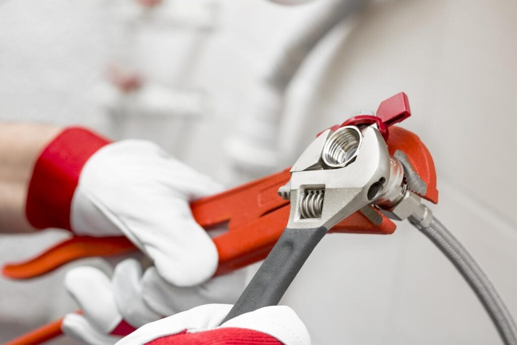 Plumber holding pipe wrenches for an emergency repair in Palm Harbor