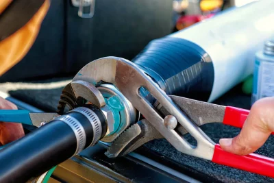 Technician tightening an industrial pipe connection in Palm Harbor