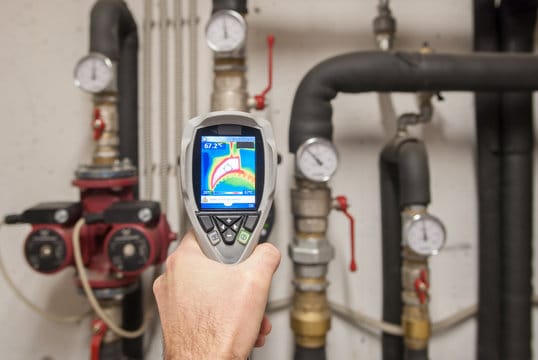Plumber using a thermal imaging camera to inspect pipes in Palm Harbor