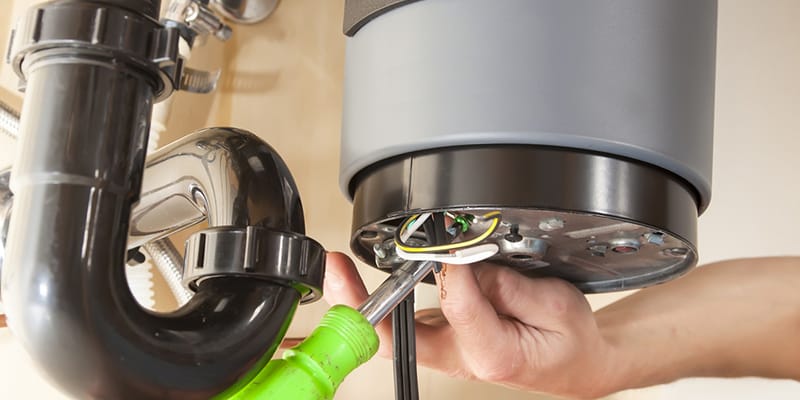 Technician repairing the heating element of a water heater in Palm Harbor