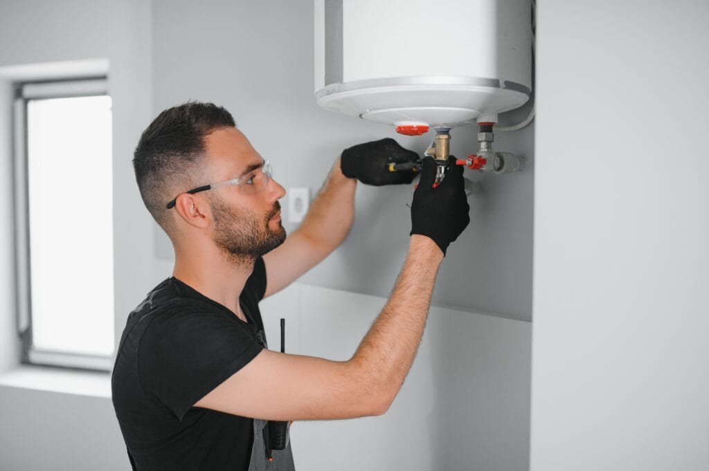 Technician performing water heater maintenance in Palm Harbor