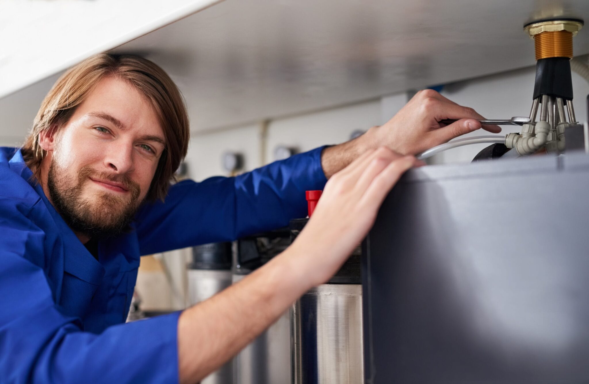 Technician servicing a residential water heater tank in Palm Harbor