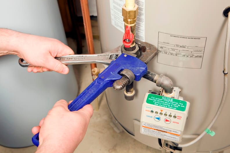 Plumber repairing a water heater valve in Palm Harbor